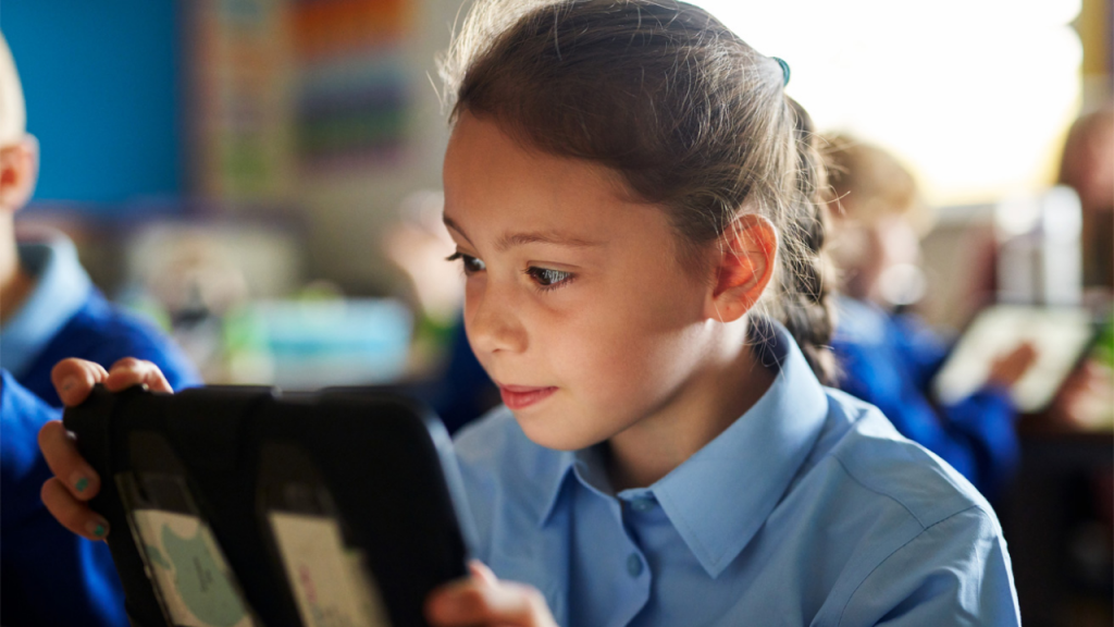 child-reading-ipad-school-uniform